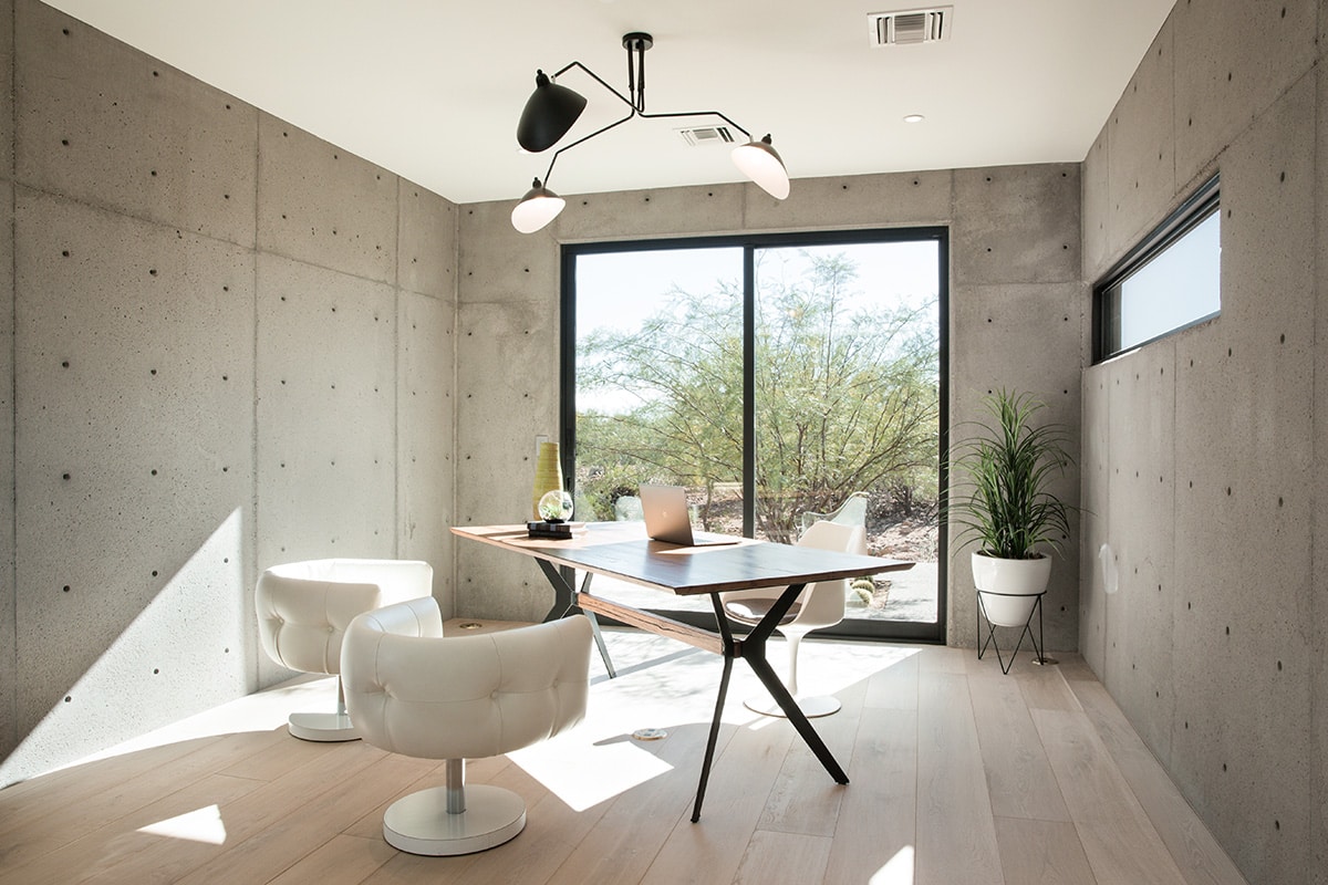 An organic palette of materials and Western Window Systems’ sliding glass door give this home office a modern feel.