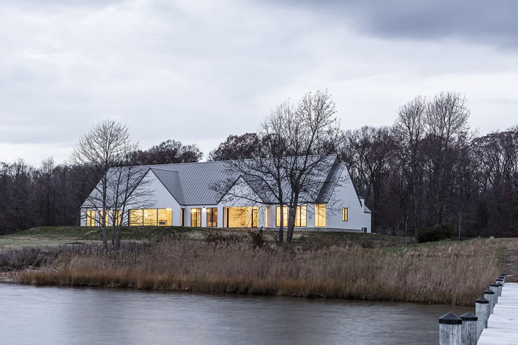 The property gives a nod to the area’s bucolic heritage through elements like vertical plank siding, a seam metal roof, and gables.