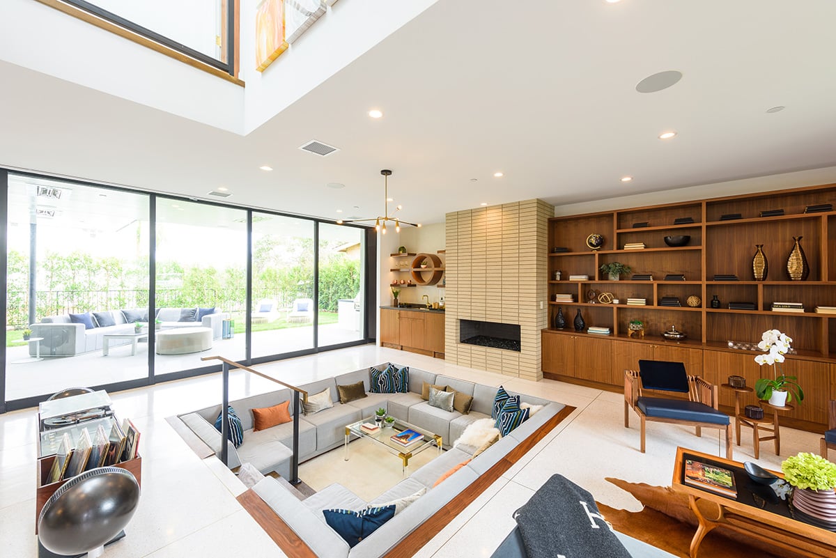 A huge four-panel multi-slide opens from the great room to an outdoor living space.