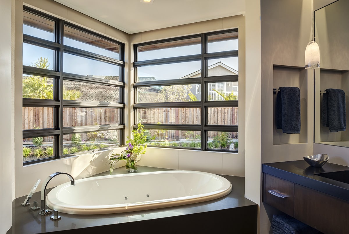 A V-shaped popout with stacked windows where the master bathroom’s tub is pays homage to Frank Lloyd Wright's style of architecture