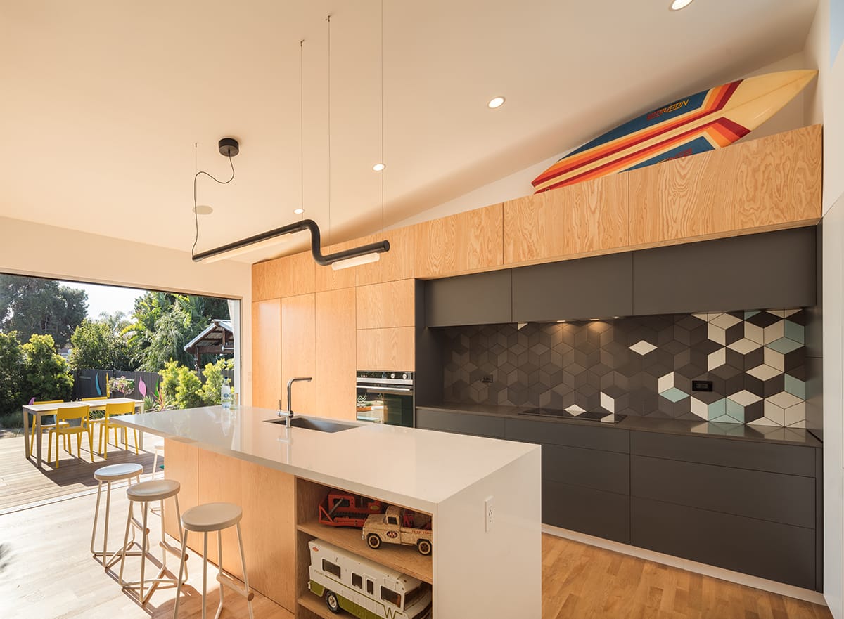 Dining al fresco has never been easier thanks to the indoor-outdoor living possibilities presented by the giant multi-slide door in the modern kitchen.