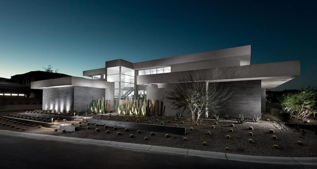 The home’s design has a strong connection to the natural desert landscape through its use of stone on the façade and copious number of windows.