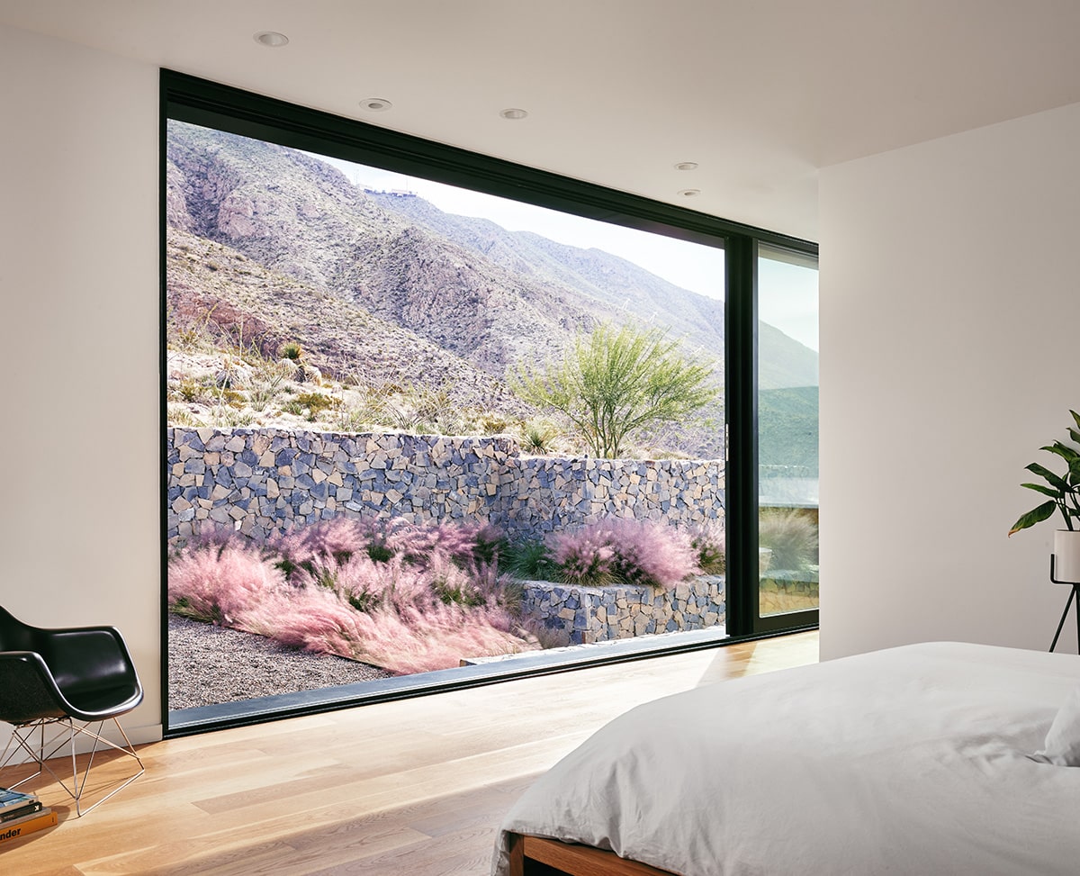 A multi-slide door in the master suite opens to the natural mountain preserve.