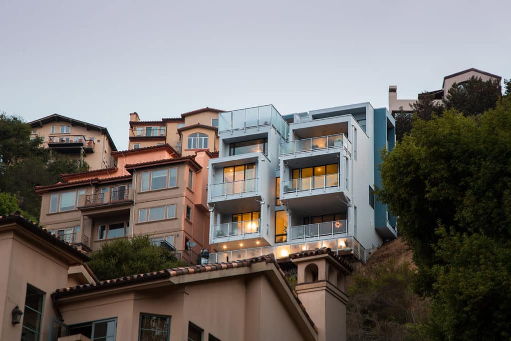 Sliding glass doors on each balcony leads to the home’s interior rooms.