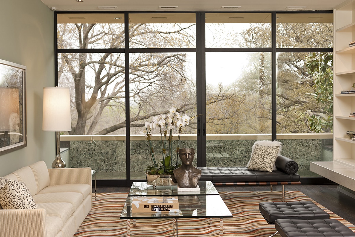 When closed, this parting sliding door frames lovely views of a wooded area near Fort Worth.