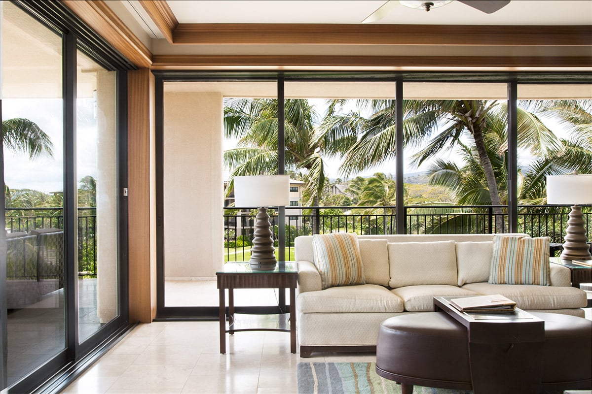 Multi-slide doors meet at a post in the corner of the room while framing beautiful views.