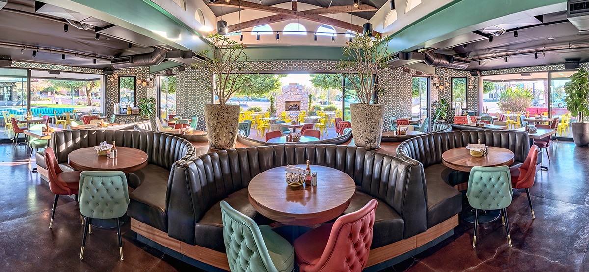 A panoramic view from inside the restaurant showcasing multi-slide doors on three different walls.