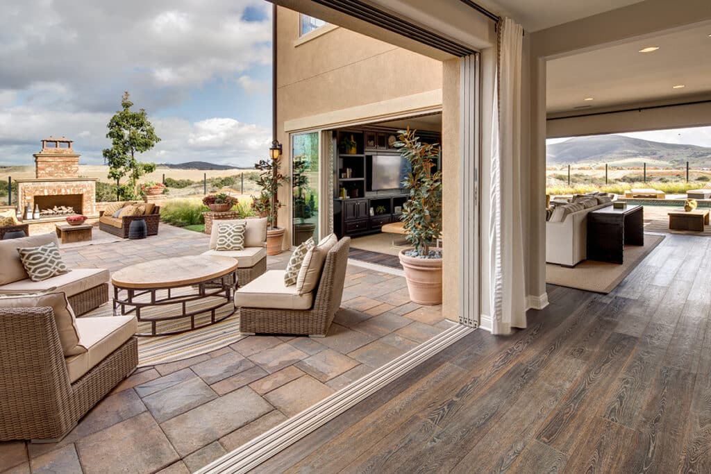 A floor-to-ceiling multi-slide door is pocketed to allow an outdoor seating area to merge with the indoors.