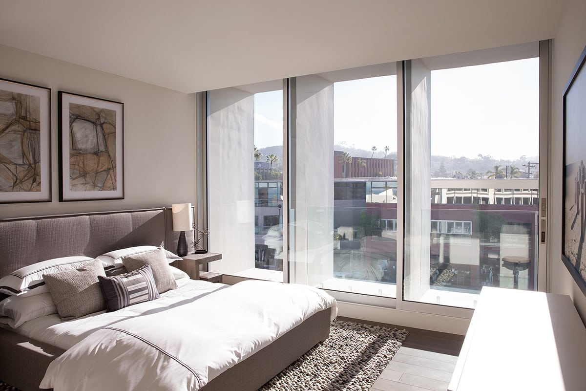A large multi-slide door in the bedroom opens the room to the outside.