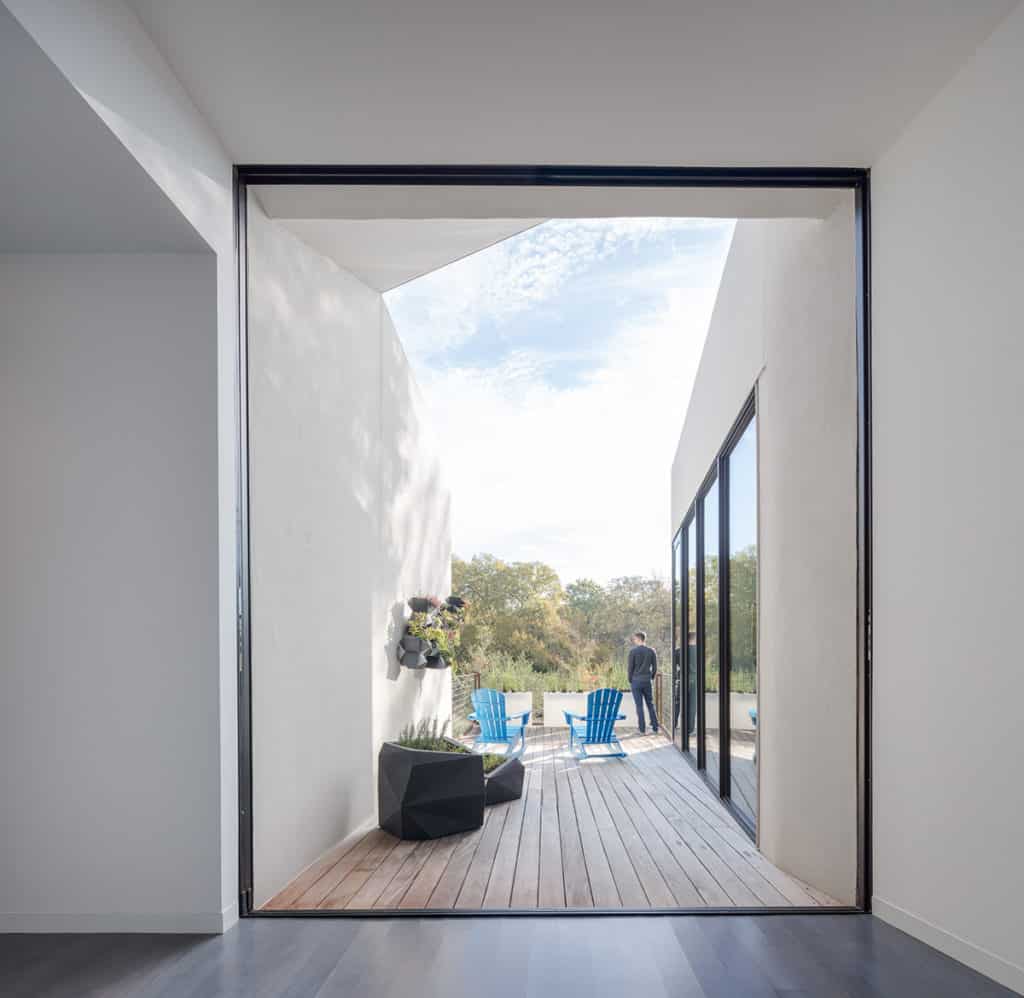 A huge pocketing multi-slide door leads to a wooden deck.
