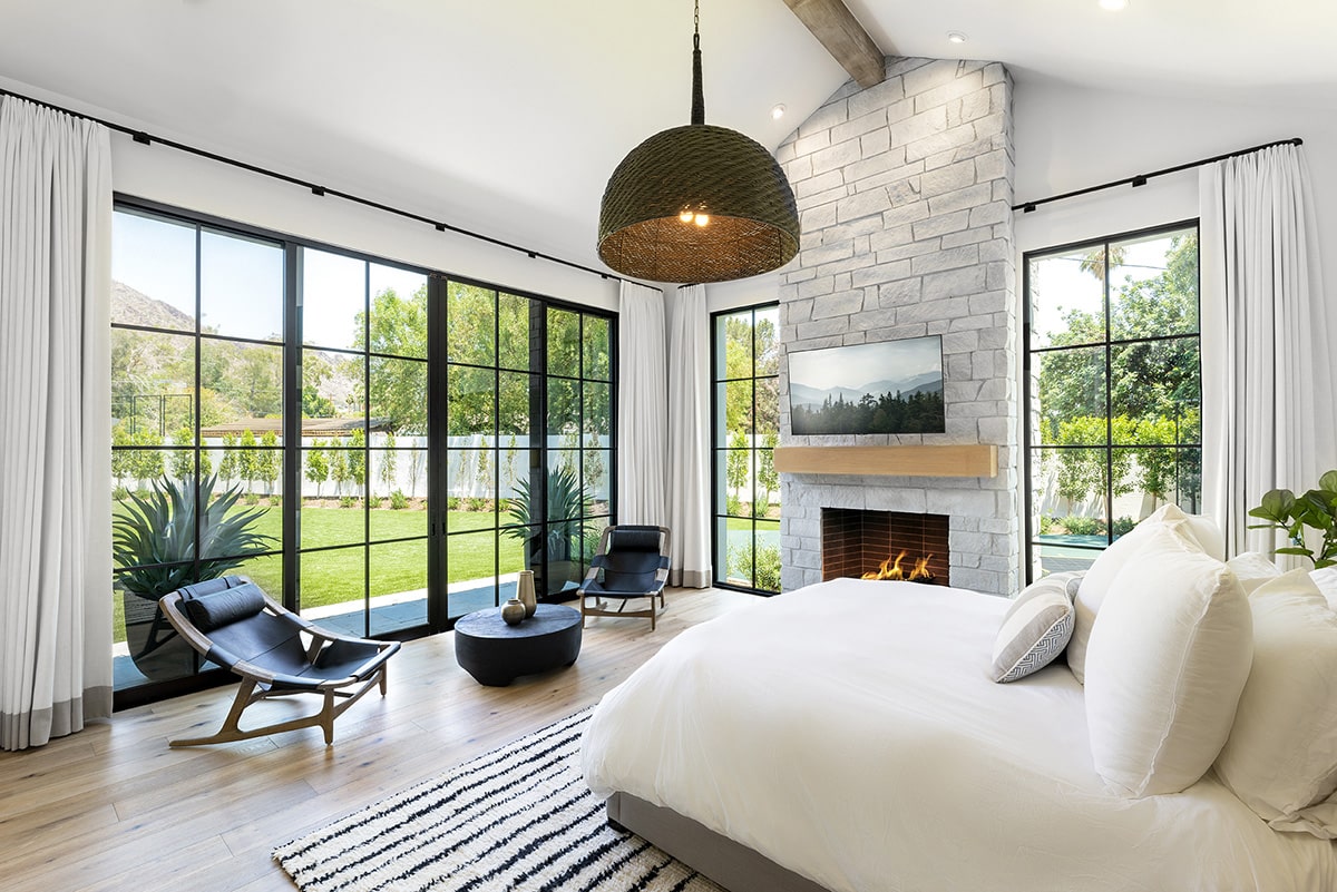 The bedroom multi-sliding glass doors and fixed windows provide a beautiful view of the backyard first thing in the morning.