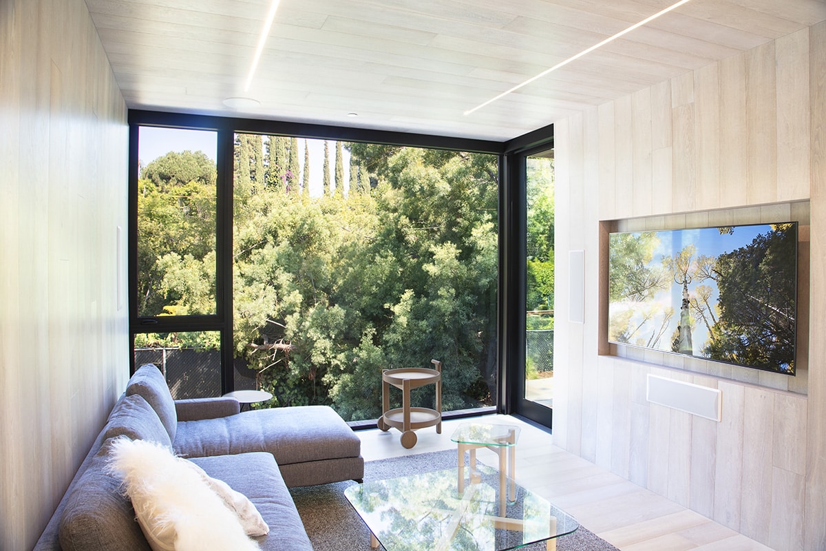 Copious glass provides vernal views of the surrounding woodlands from various rooms.
