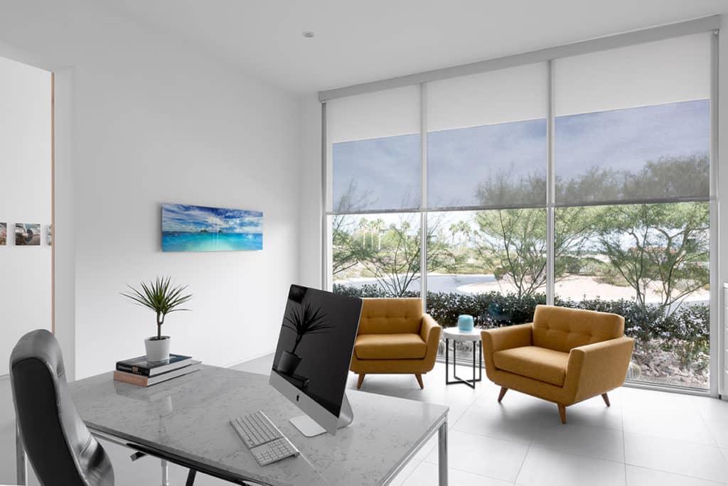 Glass makes up almost half the structure in Shades of White, showcased by this home office with a full window wall opposite the desk.