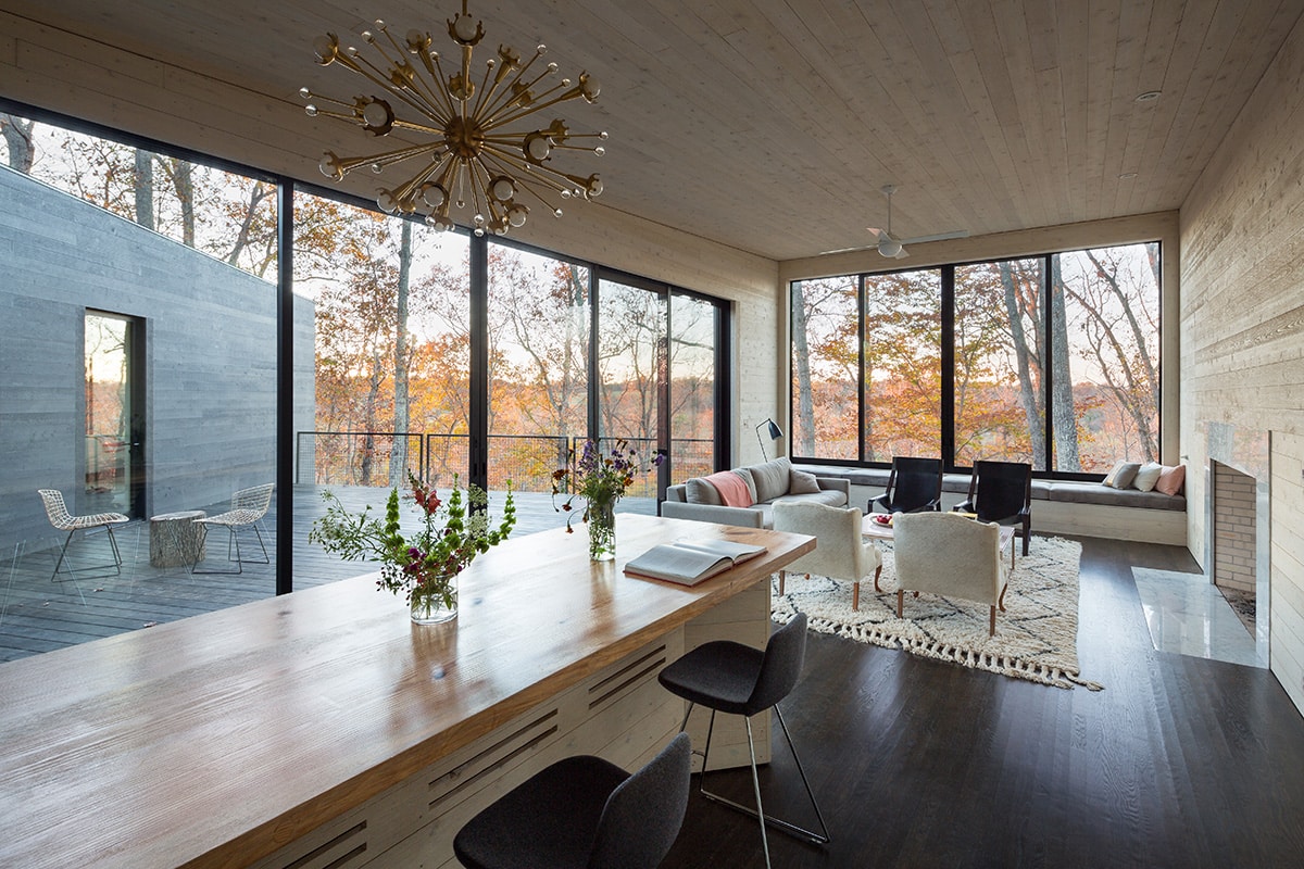 Wall-length glazing frames the surrounding forestry in the great room.