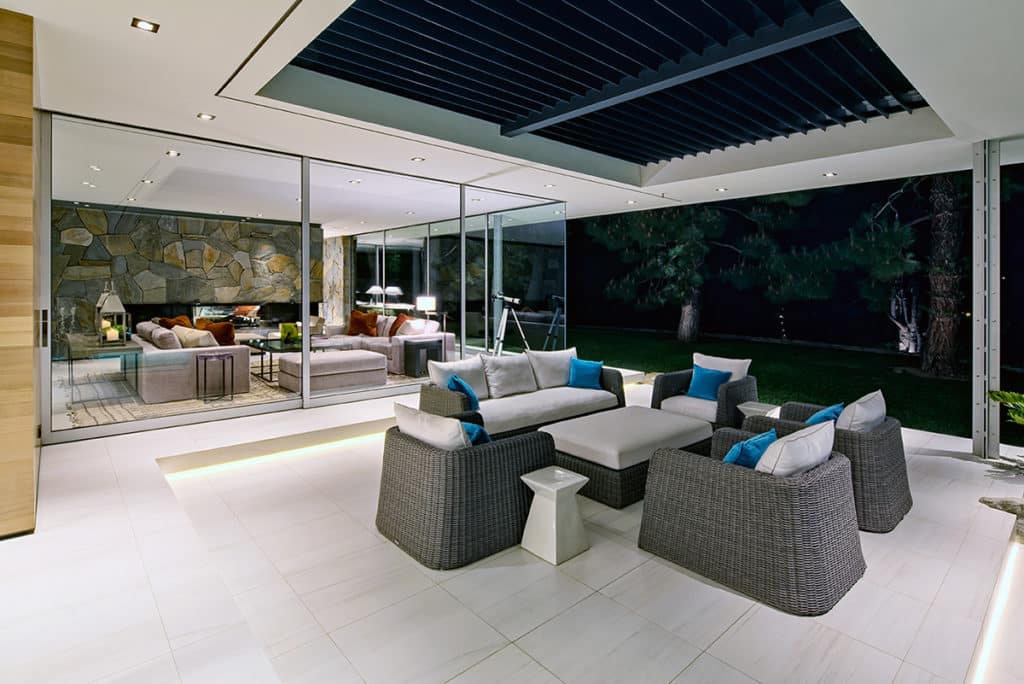 At night, the giant multi-slide paints an inviting picture of the home’s living room.