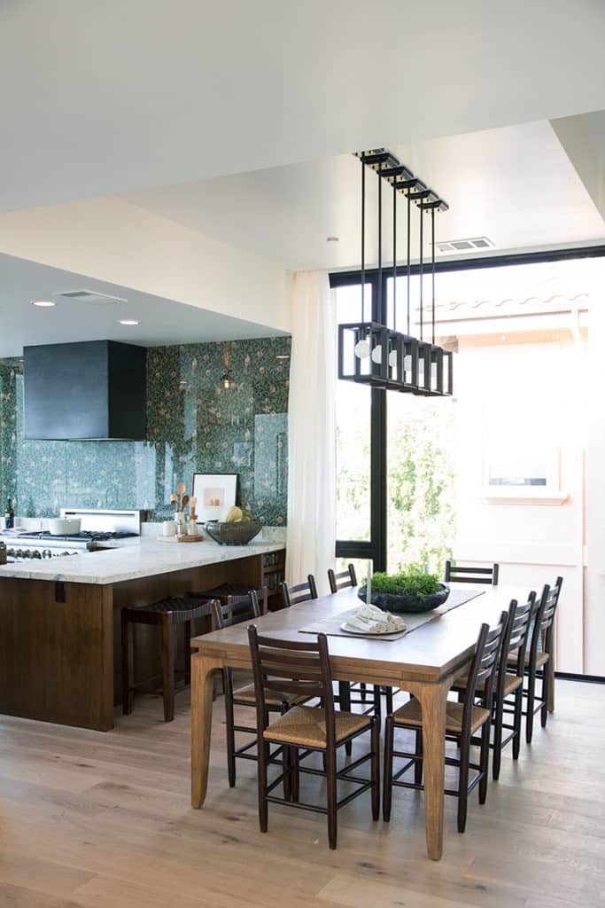The dining room and kitchen are flooded with light from the large amount of glazing throughout the home.