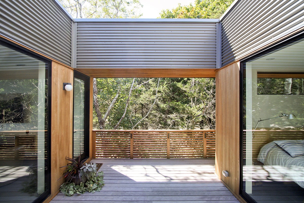The prefabricated home has stellar views of the surrounding trees and waterfront, with large glass walls opening rooms to the views.