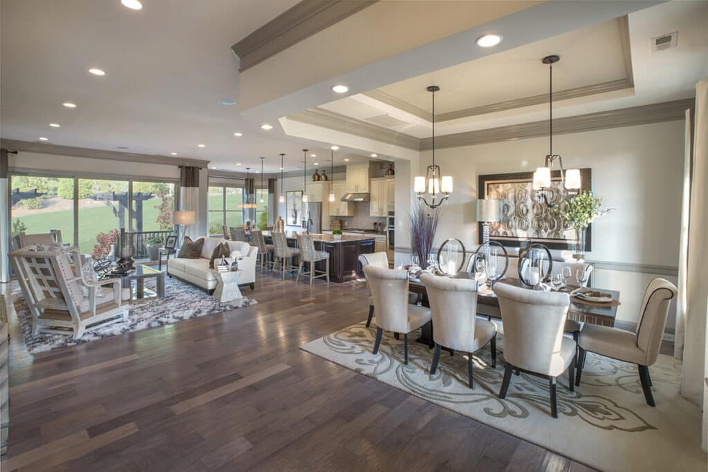 Moving glass walls let natural light into a cozy ivory-toned dining room.