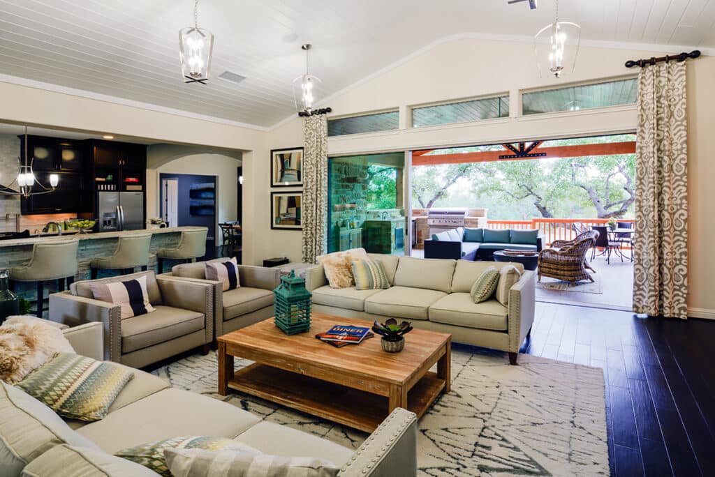 An indoor living area expands to the outdoors through a huge multi-slide glass door.
