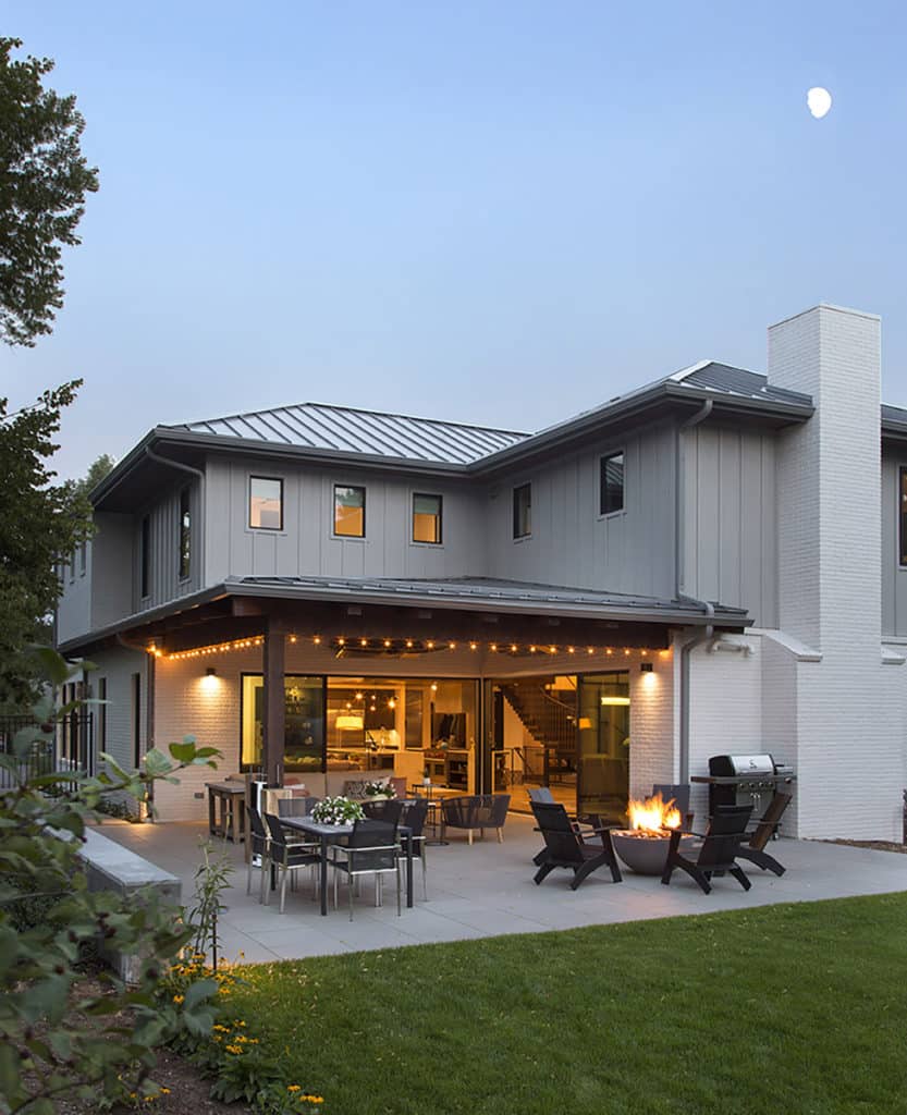 Two stacking divided lights multi-slide doors seamlessly blend the indoors with the outside inside a big office.