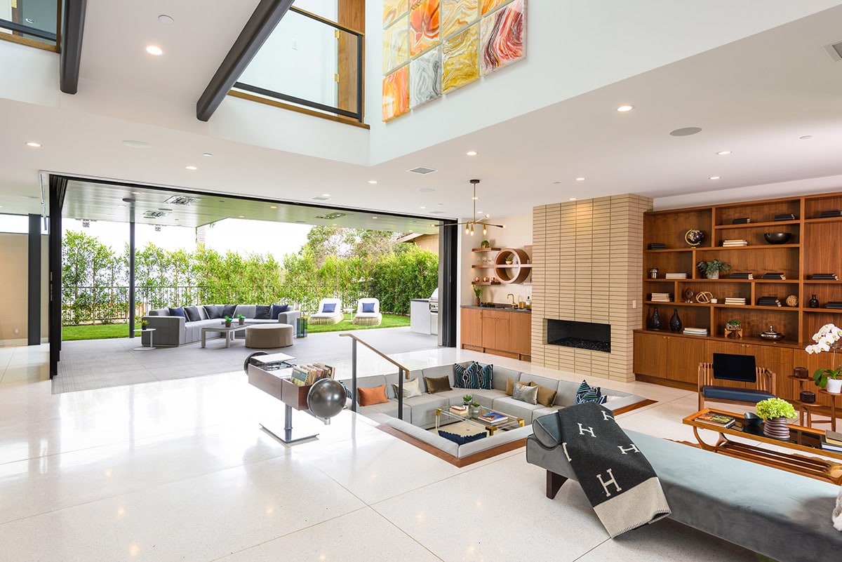 The transition from the indoors to the outside is blurred with this massive multi-slide connecting the indoor living room to the outside seating area.