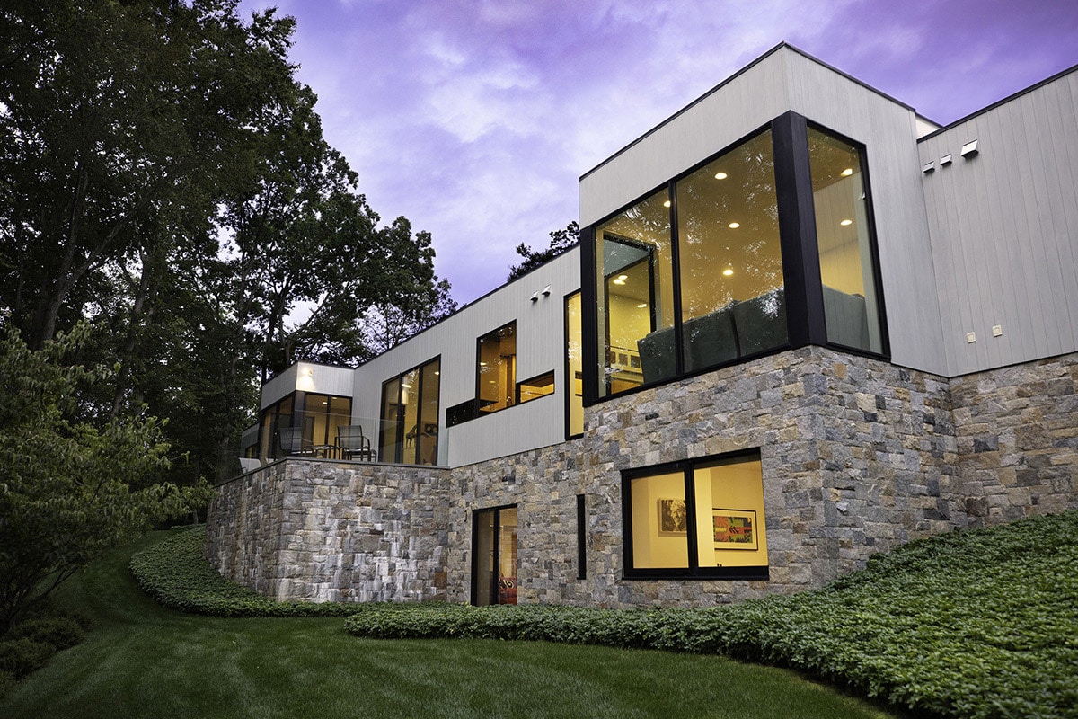 A combination of indigenous materials and big glass accentuate the balance of nature and art throughout the two-story home.