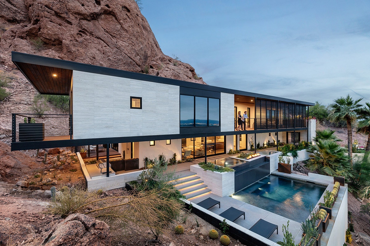The stacking, multi-slide doors open rooms on both floors of the house to the outside patio and pool.