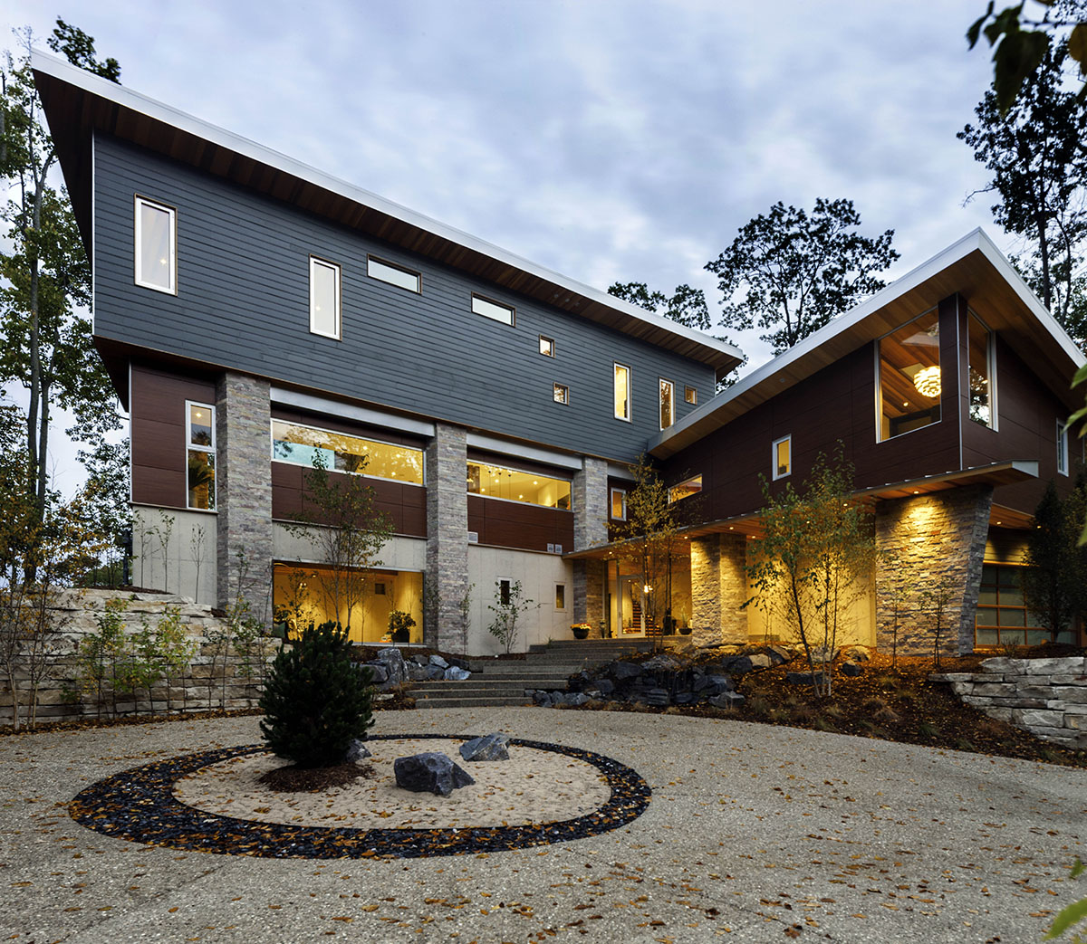 A front view of the home with windows of all sizes dotting the three-story home.