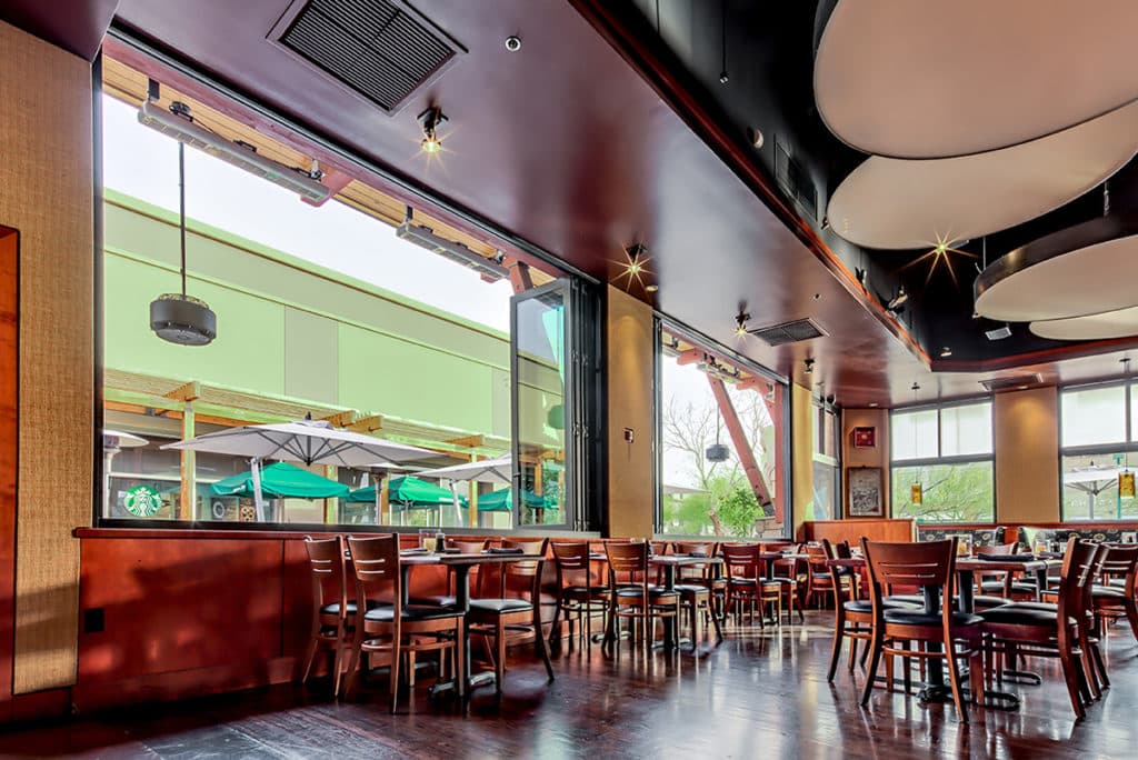 When fully open, the bi-fold windows provide a view of the shopping plaza.