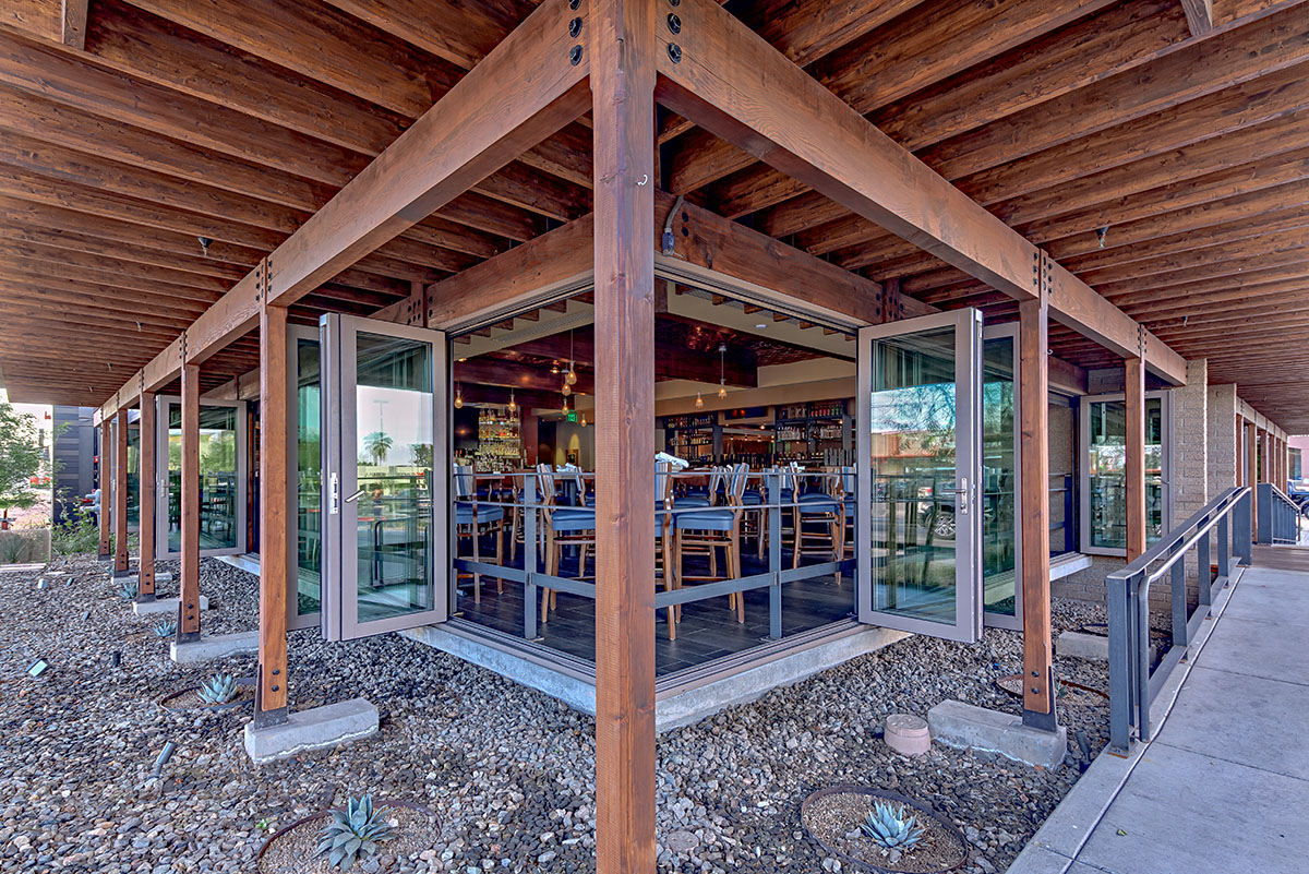 Thin sightlines, durable hardware, and contemporary appearance make these bi-folds perfect for indoor-outdoor dining experiences.