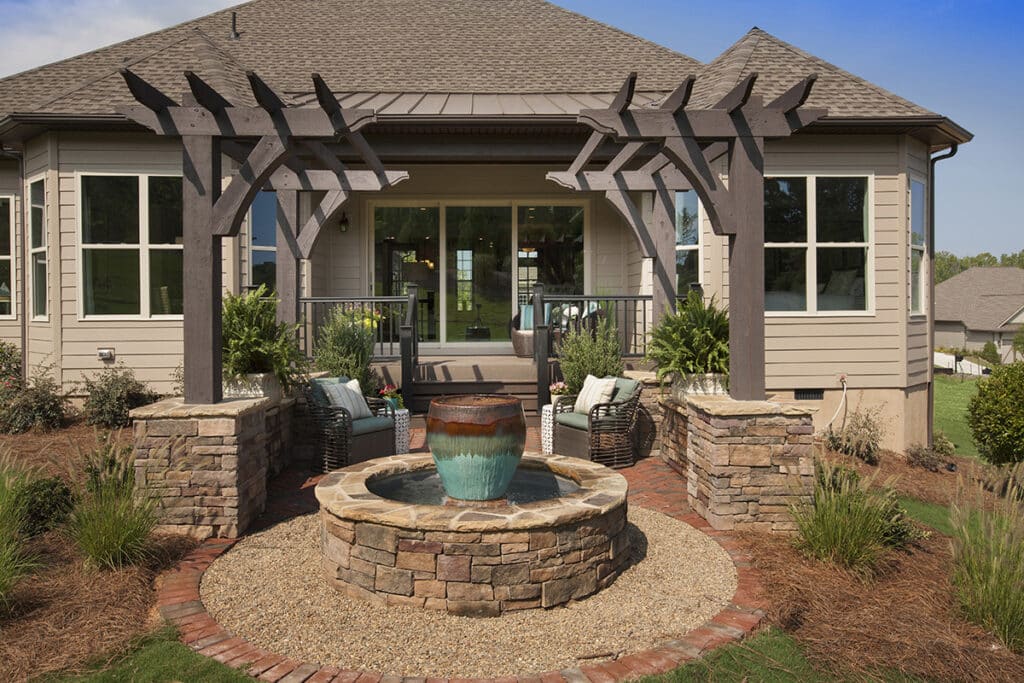 A close view of an outdoor seating area at the back of the house with a multi-slide glass door that leads inside.