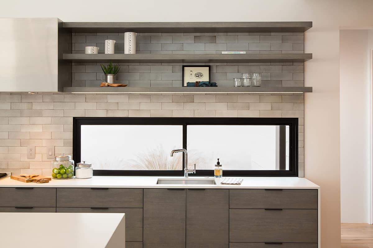 Western Window Systems casement windows provide a view from the kitchen sink.