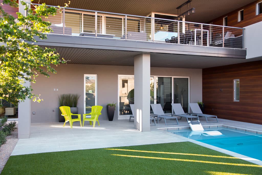 The backyard connects to the home through large, sliding glass doors.