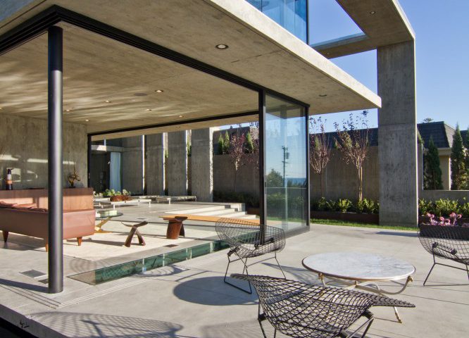07-resica0010_0000001_final-21 A view of a patio blending into a sun room via an open multi-slide door.