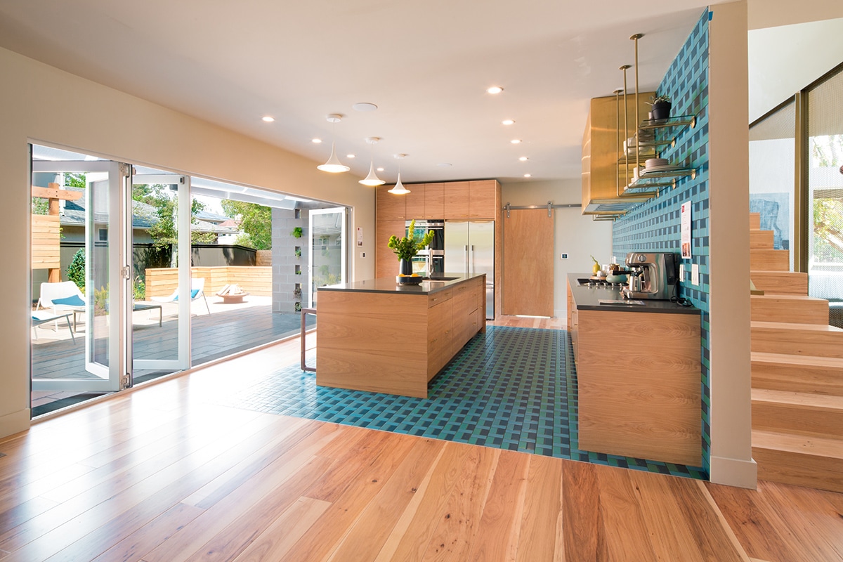 With the bi-fold door open, the kitchen and dining choices are opened to the backyard patio.