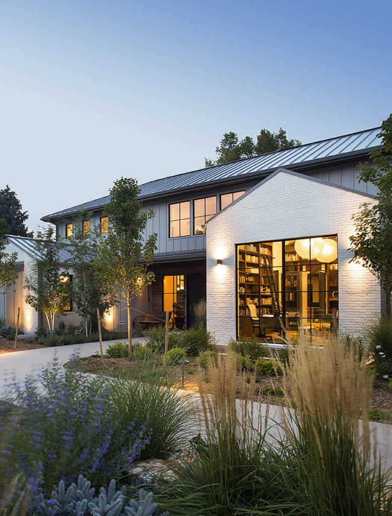 Big glass on the facade provides an inviting look into the remodeled home.