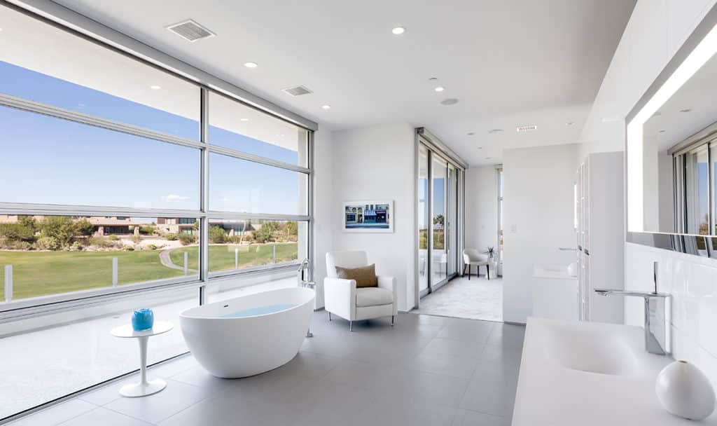 A wall of windows bathes the bathroom in California sunshine.