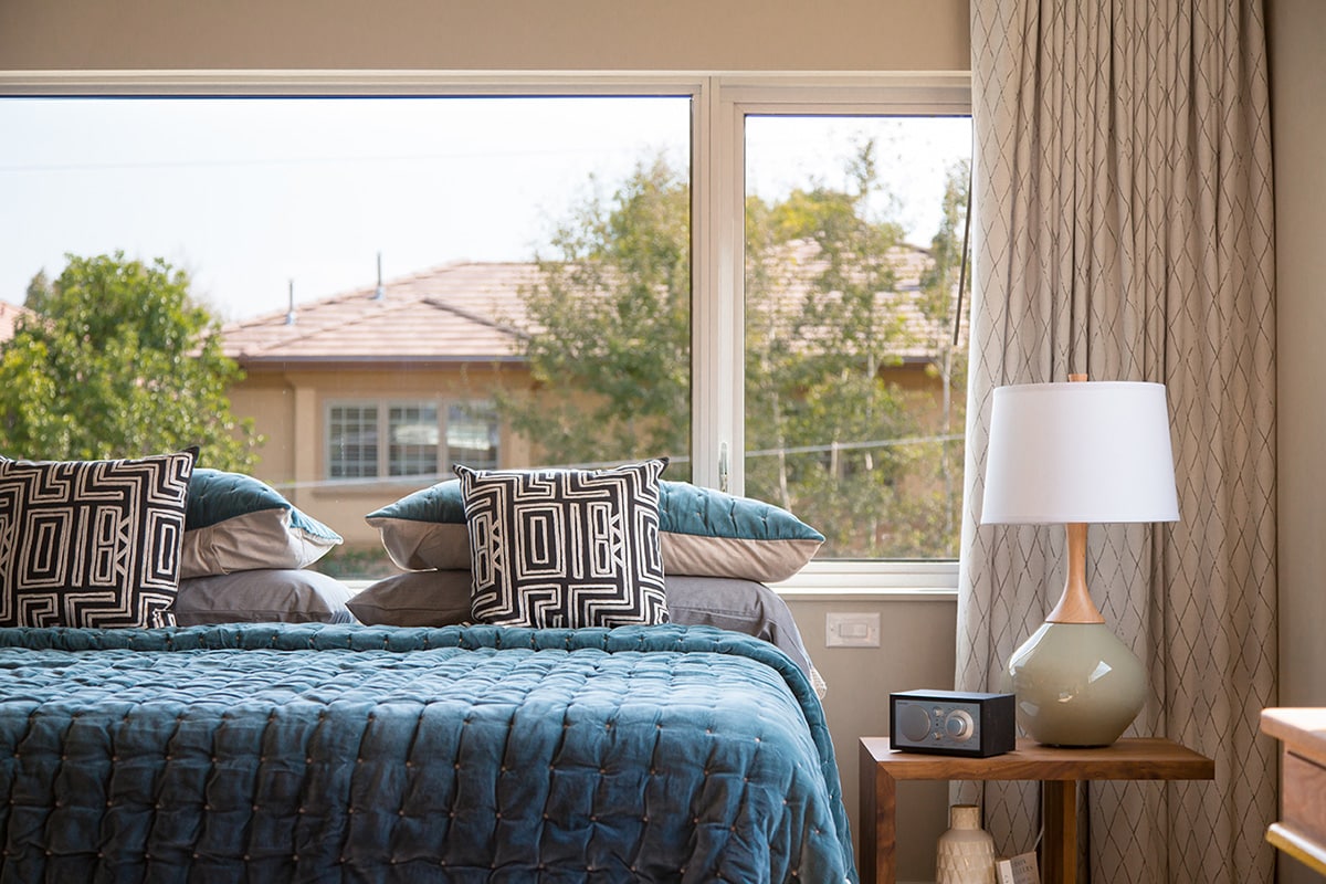 A combination of fixed and operable windows add life to this bedroom.
