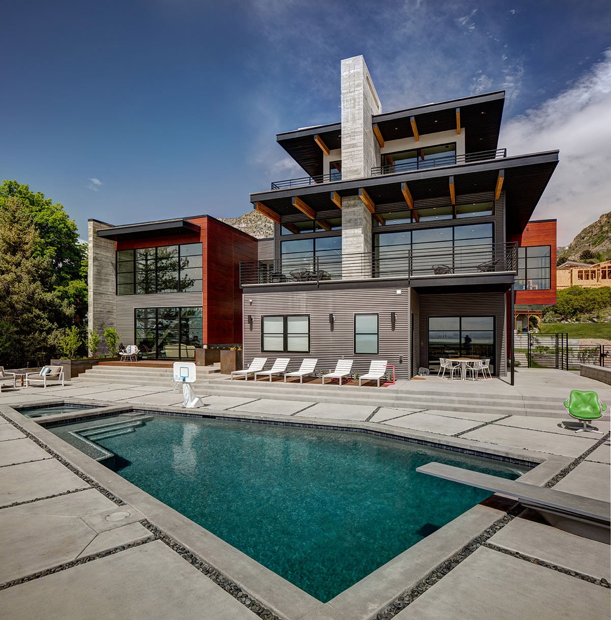Each level of the mountainside home provides another opportunity for stunning views and outdoor access through numerous windows and glass doors