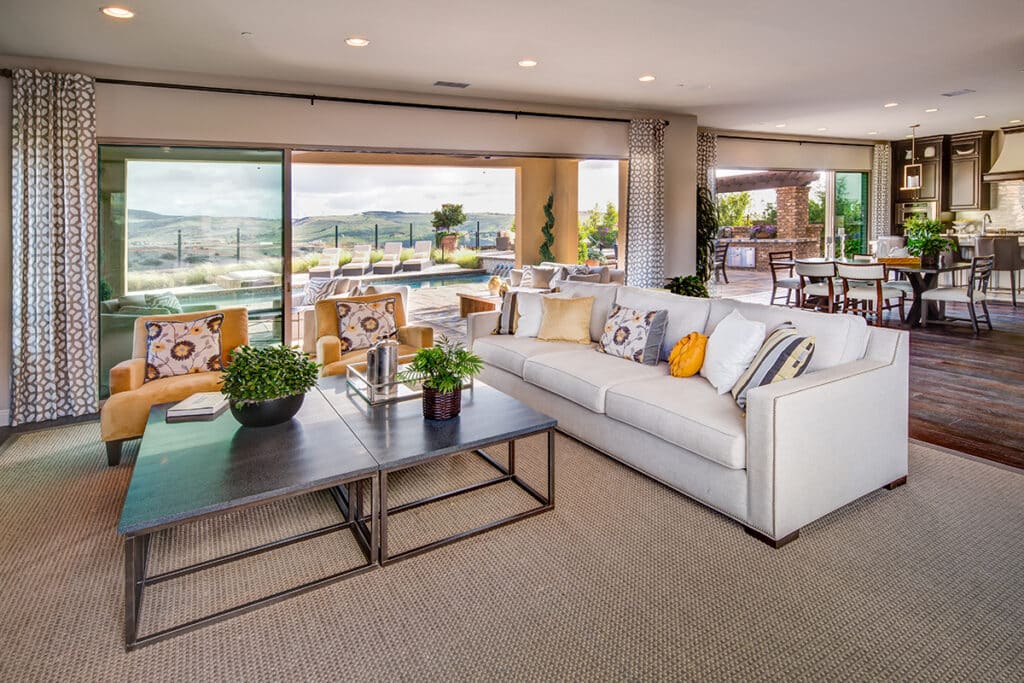 A living room is connected to the backyard through a large multi-slide glass door.