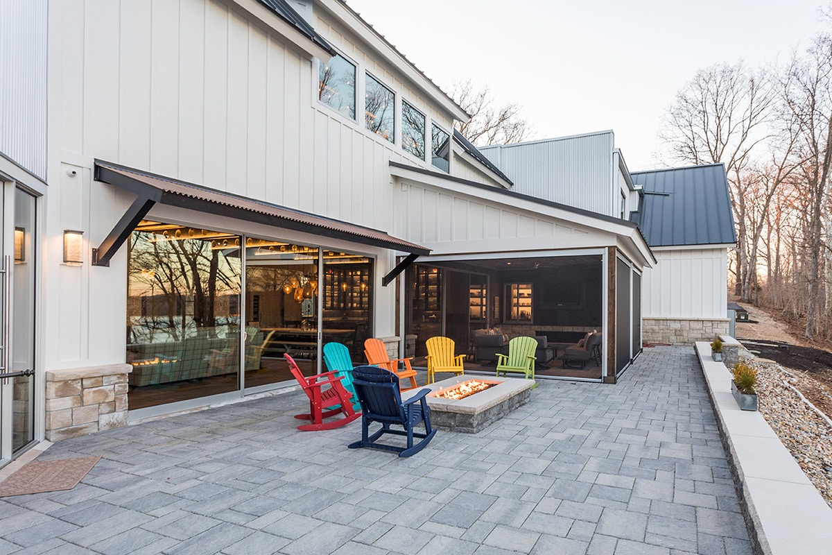 A multi-slide door seamlessly merges the great room to a fire-lit back patio.