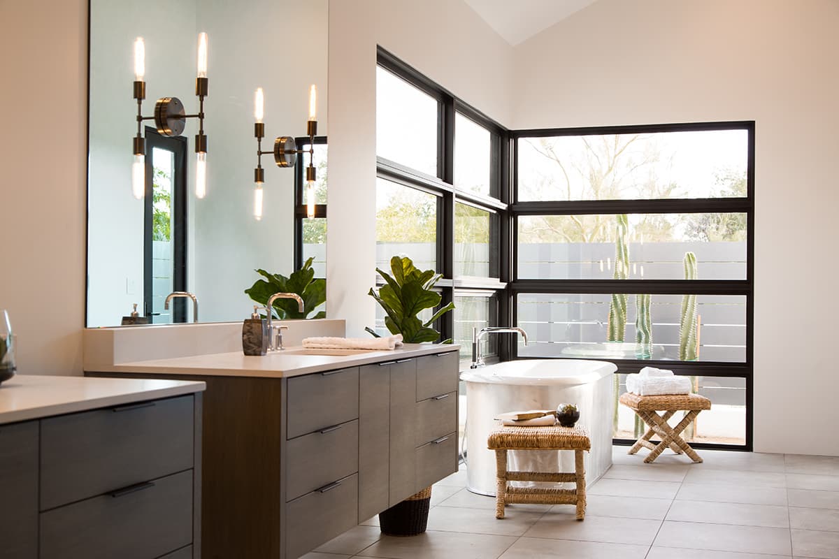 A wall of windows behind the bathtub bathes the master bathroom with natural light.