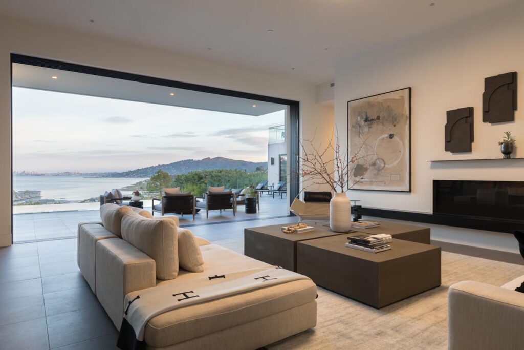 Living room with multi-slide doors tucked away revealing the San Francisco Bay view.