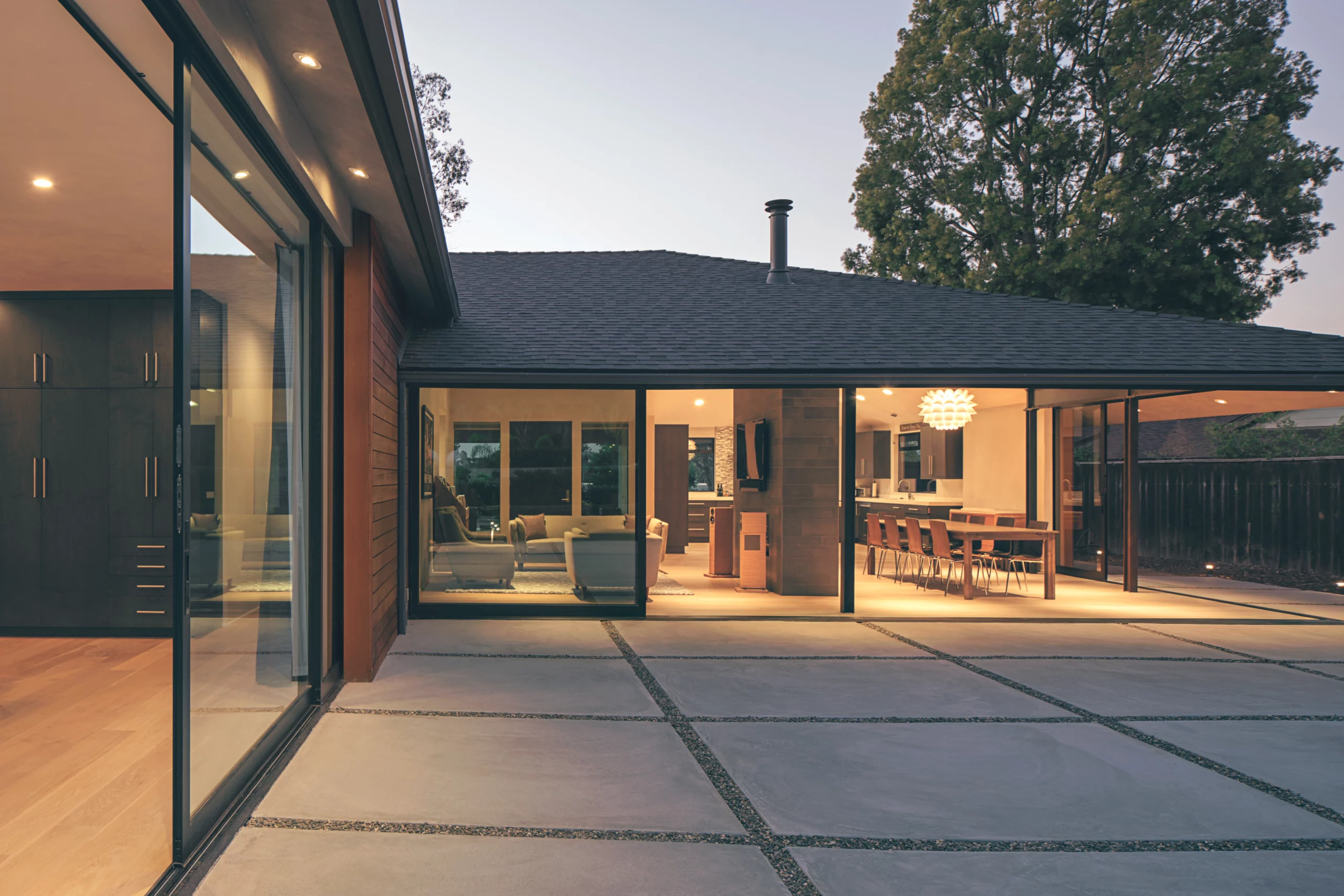 This view of the main living area from inside the master bedroom shows how two 90-degree multi-slide doors seamlessly blend the indoors with the outside.