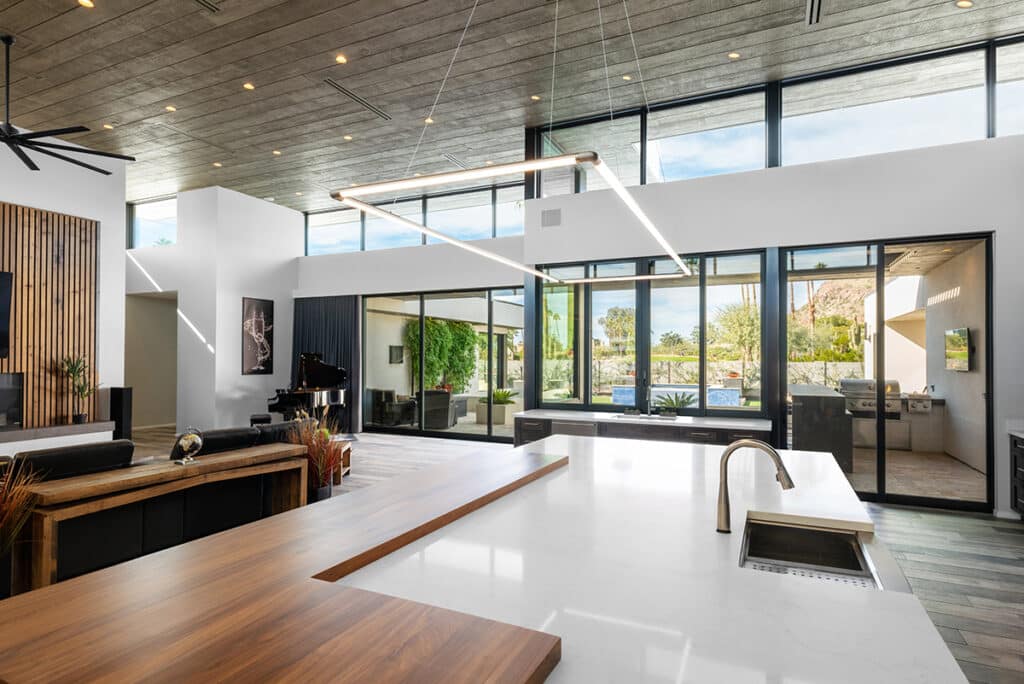 A view from the kitchen of clerestory windows and sliding glass doors that show views of the backyard.