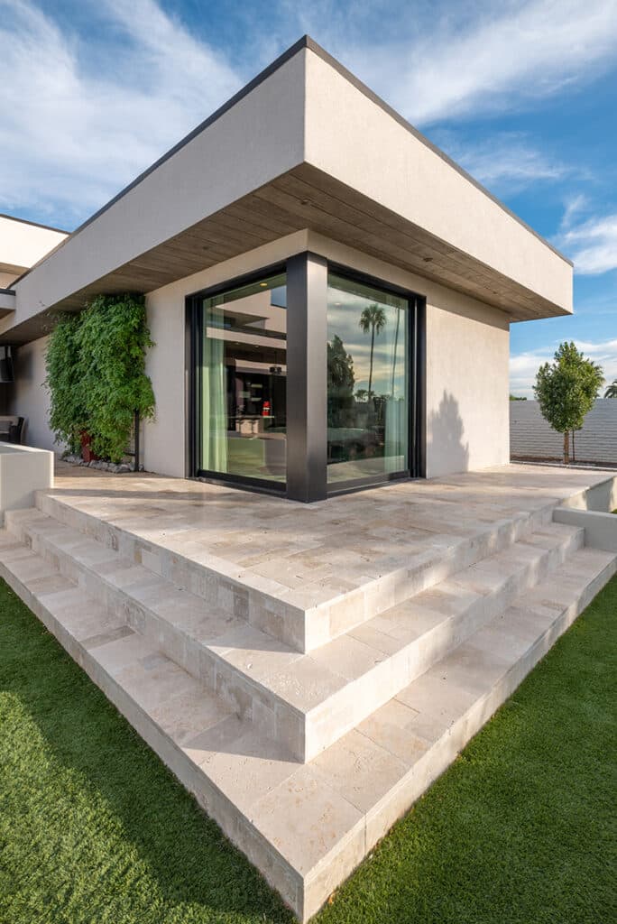 A view of the bedroom 90-degree configuration with the doors closed, at the top of patio stairs to the backyard.