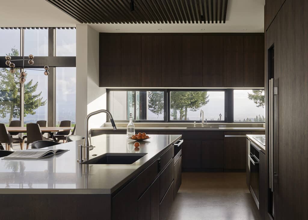 A view of the kitchen with sliding windows above the sink.