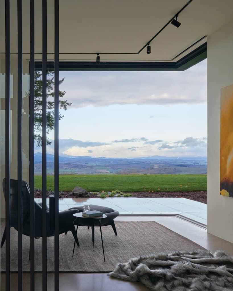 Fully opened 90-degree sliding doors completely open a corner of the room to the backyard.