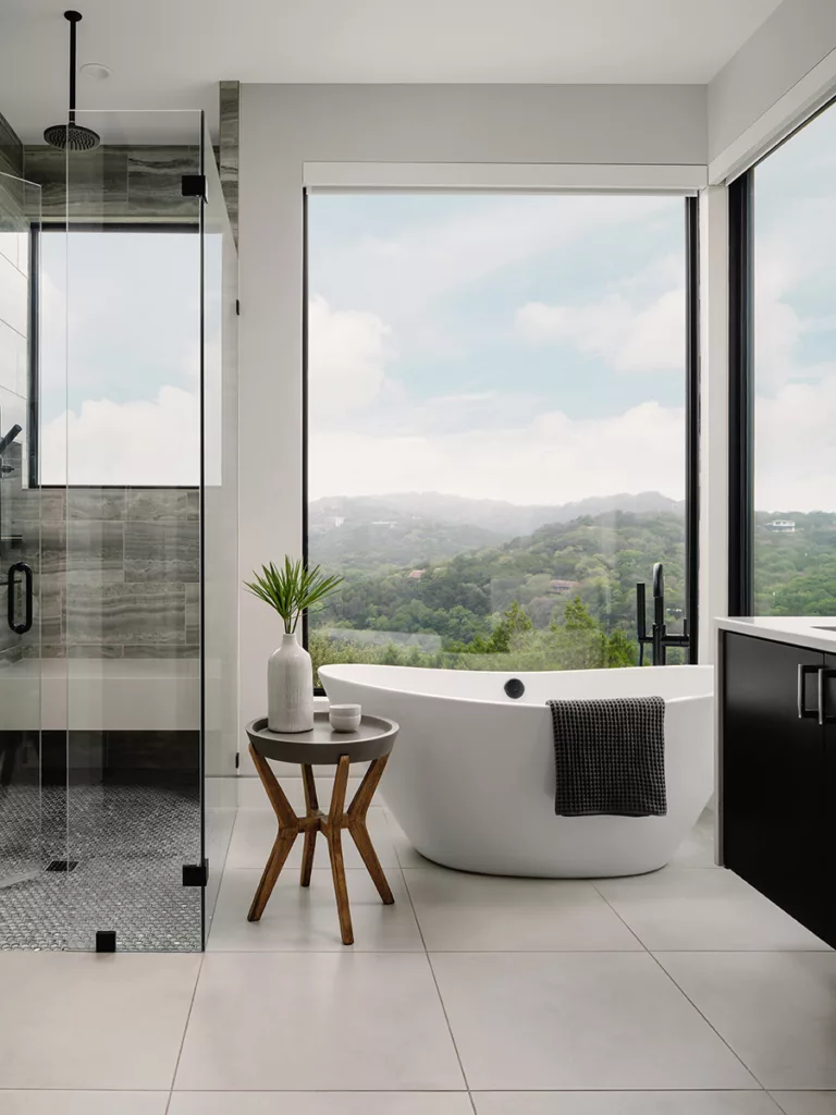 Two large, fixed windows provide views for the bathroom.
