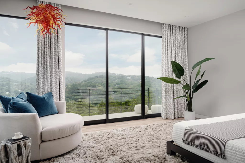 A view of the hills from the bedroom through a sliding glass door.